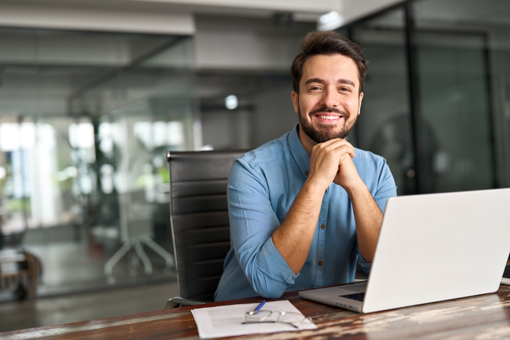 male marketing professional at desk with computer